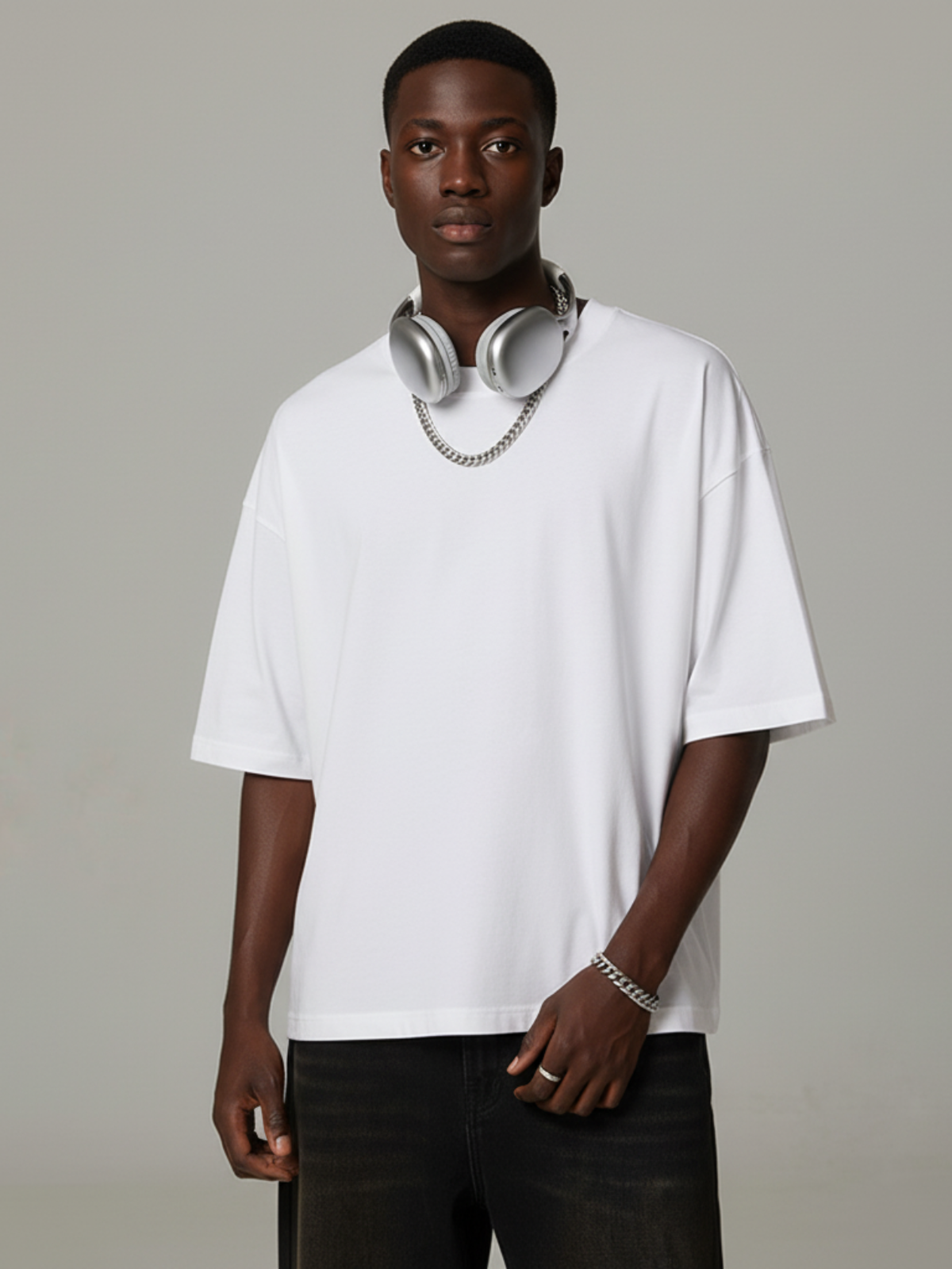 Aero boxy crop tee in white by Apollo Moda, styled with black pants and headphones