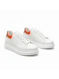 Men's Pluto Ember by Apollo Moda, white leather low-top sneaker with orange accents, third angle